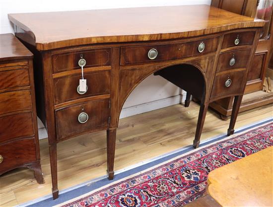 A George III cross-banded mahogany serpentine sideboard W.162cm